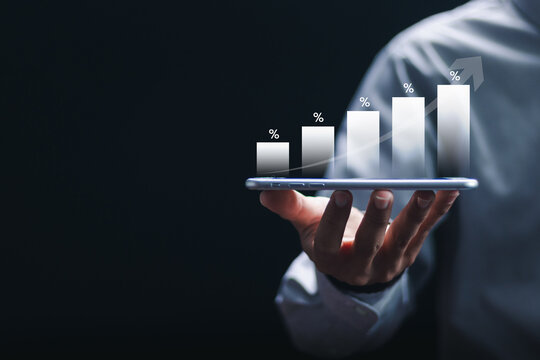 Businessman holding smartphone with percentage financial growth graph of company. Financial goals and global economic business planning. - Powered by Adobe