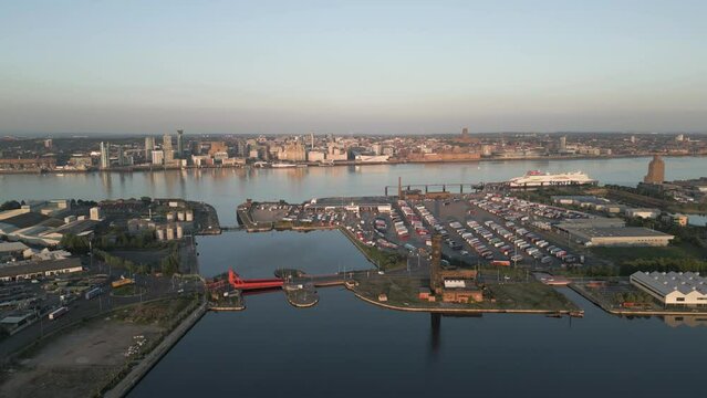 Slow approach view of Birkenhead Docks with the River Mersey and Liverpool skyline in the background, Wirral, England