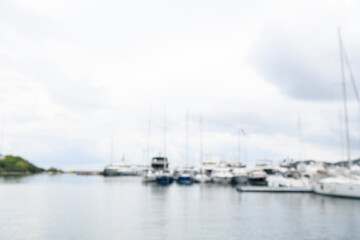 Blurred background sailing yachts in marina. Summer abstract defocused background. Yachting concept.