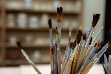 A set of tools, brushes for sculpting from clay in the workshop, drawing, at the workplace. Close...