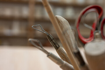 A set of tools for sculpting from clay in the workshop, at the workplace. Close up, place for...