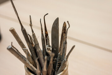 A set of tools for sculpting from clay in the workshop, at the workplace. Close up, place for...