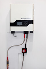 Hybrid Solar Inverter on Wall. Hybrid Inverter. Lithium battery pack and EV charger.