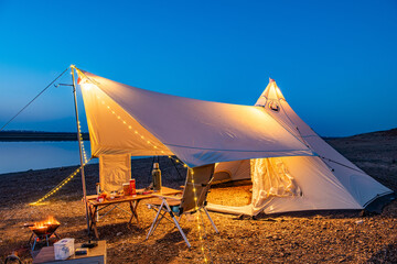 tent on the beach at sunset