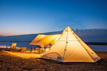 tent on the beach at sunset