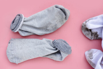 Dirty socks on pink background.