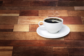 Coffee cup and white saucer on a wooden background
