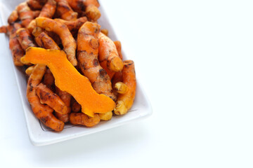 Turmeric roots on white background.