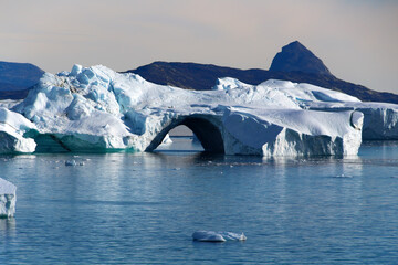 Arctic, iceberg with hole in Uummannaq fjord, Greenland, Denmark
