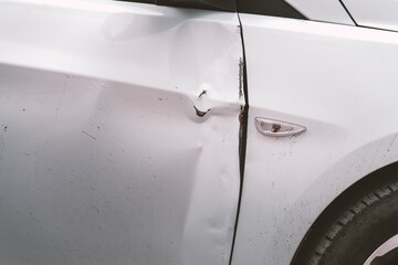 Dent and scratches on car door after accident, detail, close-up, side view