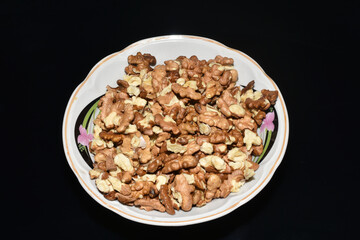 A plate filled with walnuts.