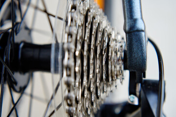 Fototapeta na wymiar Shifting gears on rear transmission of bicycle. Bicycle gear drivetrain and cassette, close up. Maintenance bike transmission