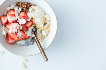 Chia pudding with ricotta, strawberries, granola and nuts.