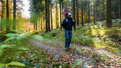 Papa und Tochter wandern im Herbst im Wald