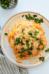 Whole cauliflower baked in spices and tahini dressing.