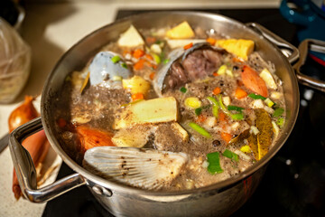 Preparation of fish soup in pot.