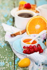 Delicious breakfast with fresh coffee, fresh waffles and fruits