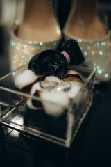 close up view of white flowers, wedding rings in rustic box with plants inside