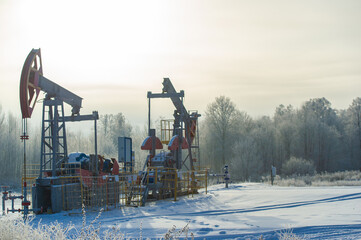 Pumpjack Experience the mesmerizing beauty of oil pumps against a backdrop of glittering frost....