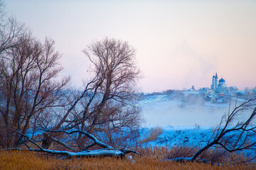 Behold the charm of nature's art! Venture into this snow-covered landscape and notice the majestic Orthodox Church standing proudly amidst the winter beauty.