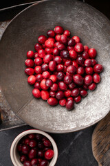 Fresh, ripe, red cranberries in a heap.  Ripe, organic cranberry on a rustic table.