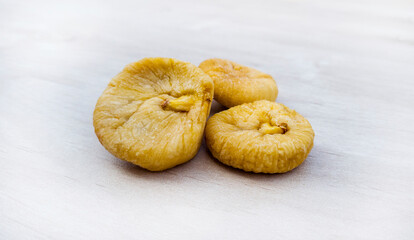 dried figs, Ficus carica. 
dried fruits for happy
Tu Bishvat.
Healthy natural food with lots of minerals and vitamins. On a white background wooden texture. with free space for text
