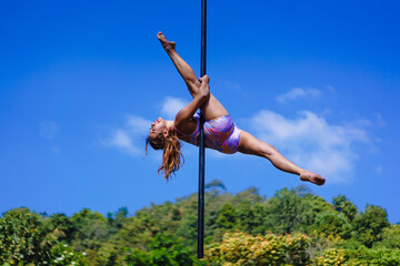 Beautiful Asian girl shows extreme advances by performing pole dance aerial in various positions...