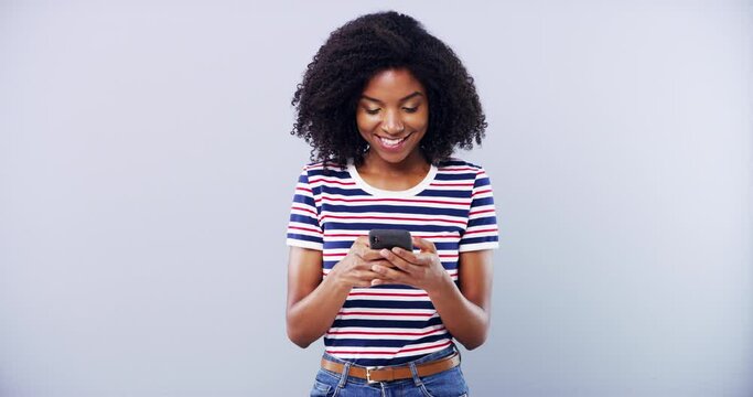 Black woman, typing on phone and smile in studio isolated on white background mockup space. Online, smartphone and happy African person scroll on mobile app, email or search internet on social media