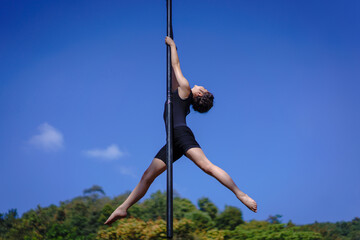Beautiful Asian girl shows extreme advances by performing pole dance aerial in various positions...