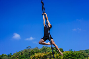Beautiful Asian girl shows extreme advances by performing pole dance aerial in various positions...