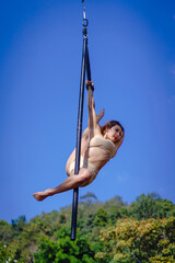 Beautiful Asian girl shows extreme advances by performing pole dance aerial in various positions...