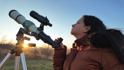 Amateur astronomer observing skies with a telescope.