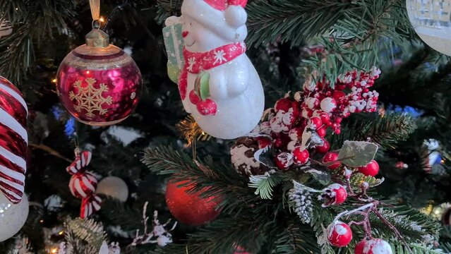 Happy snowman on the New Year tree. Christmas and New Year holiday