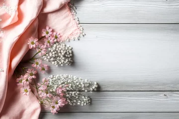 Tuinposter Hello spring concept. Top view photo of pink soft plaid and gypsophila flowers on grey wooden table background with copyspace, Generative AI © Image Alchemy
