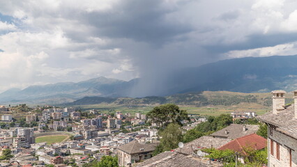 Fototapeta na wymiar Panorama showing Gjirokastra city from the viewpoint with many typical hystoric houses of Gjirokaster timelapse.