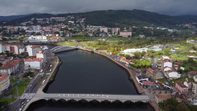 Panoramic aerial view of Pontevedra city. Famous travel destination in Galicia. River Lerez. Bridges over the river. Drone going backwards and ascending. Beautiful panorama of all region.