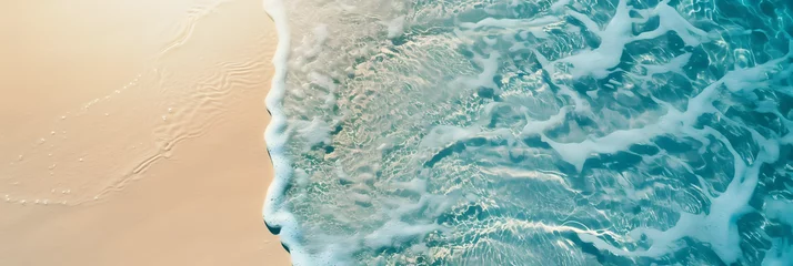 Afwasbaar fotobehang abstract sand beach from above with light blue transparent water wave and sun lights, summer vacation background concept banner with copy space, natural beauty spa outdoors © john