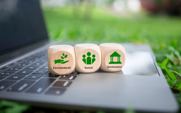 ESG concepts regarding environment, society, and governance Sustainable and ethical business Wooden cube with "ESG" text on laptop. Green energy. renewable and sustainable