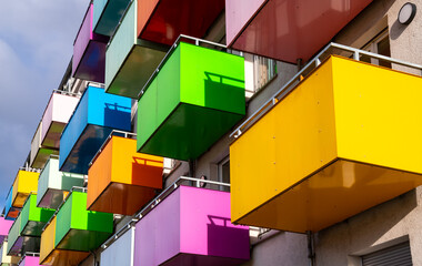 Colorful balcony parapets in yellow, green, pink, blue, orange, red, lilac, turquoise from frog...