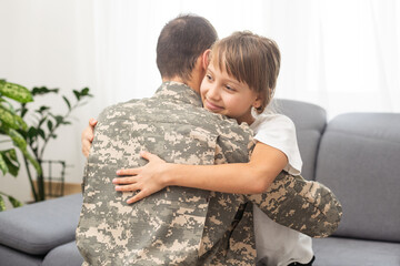 pretty little girl hugging her military father