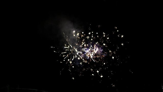 Fireworks at Night, Colorful celebration fireworks isolated on a black sky background. From below, shot of wonderful and vivid fireworks exploding. Burst. Firework. Show. New Year. Fireworks. 