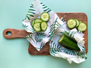 Cucumbers in beeswax food wraps. Eco-friendly and zero waste organic cotton fabric wraps to keep food fresh. Green lifestyle.