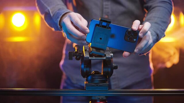 Creative filmmaker put a smartphone on tripod head with slider 4K