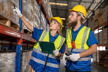 Two professional female and male warehouse checks stock workers, International car parts,...