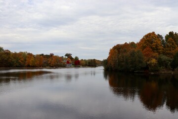 The peaceful lake in the country on a cloudy fall day.