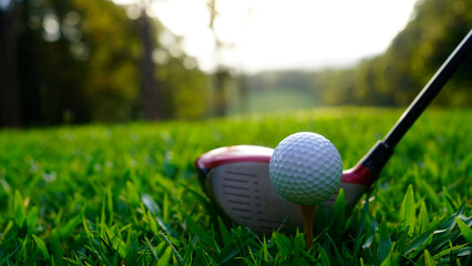 Golf ball and golf club in beautiful golf course at sunset background