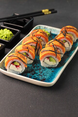 Assorted sushi nigiri and maki big set on slate. A variety of Japanese sushi with tuna, crab, salmon, eel and rolls. Top view