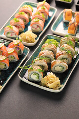 Assorted sushi nigiri and maki big set on slate. A variety of Japanese sushi with tuna, crab, salmon, eel and rolls. Top view