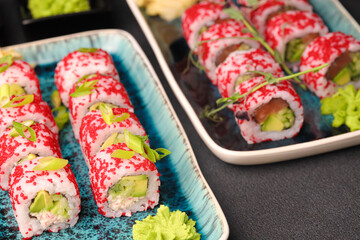 Assorted sushi nigiri and maki big set on slate. A variety of Japanese sushi with tuna, crab, salmon, eel and rolls. Top view