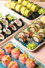 Assorted sushi nigiri and maki big set on slate. A variety of Japanese sushi with tuna, crab, salmon, eel and rolls. Top view